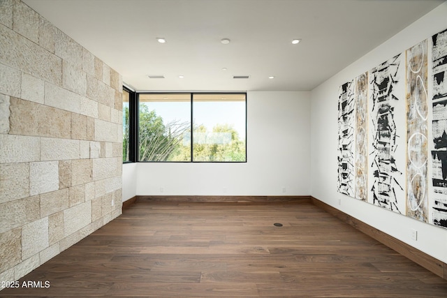 spare room featuring dark wood-type flooring