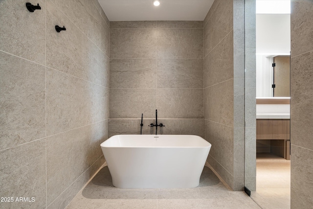 bathroom featuring tile walls and a tub