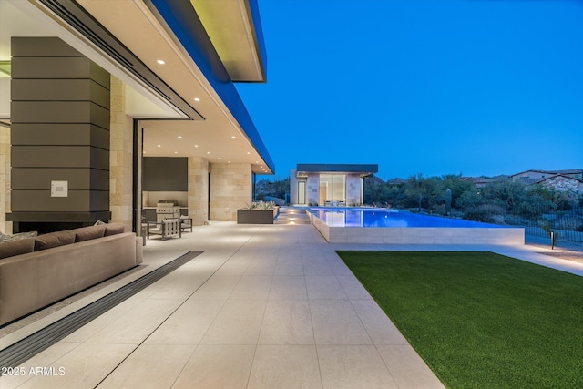 view of swimming pool with a yard and a patio area