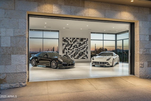 view of garage at dusk