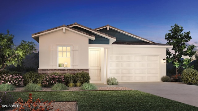 view of front facade with a garage and a lawn