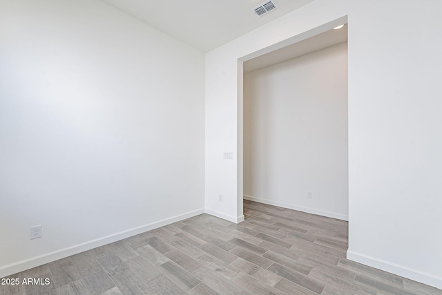 empty room with light hardwood / wood-style flooring