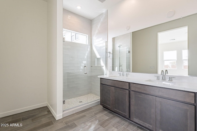 bathroom featuring vanity and a shower with door