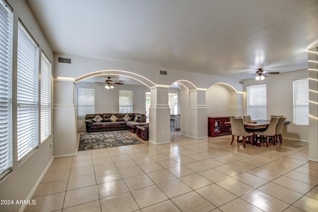 tiled living room with ceiling fan