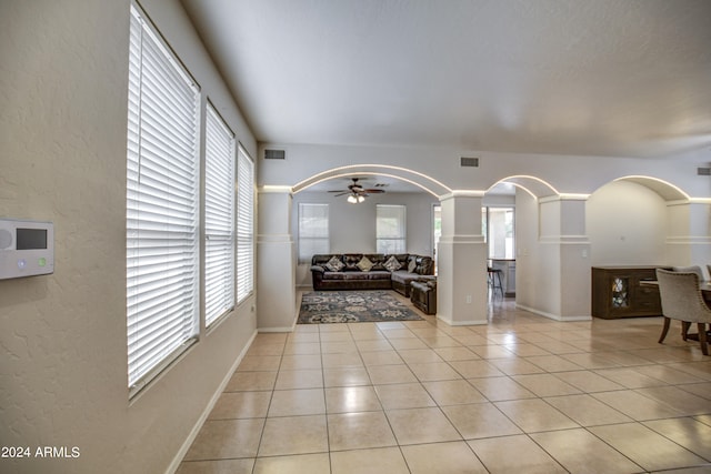 living room with ceiling fan and light tile patterned floors