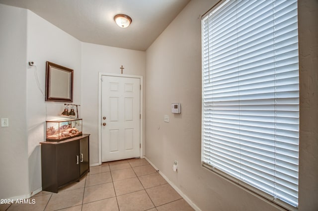 hall with light tile patterned floors