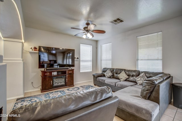 tiled living room featuring ceiling fan