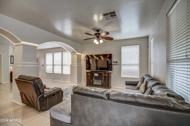 tiled living room with ceiling fan