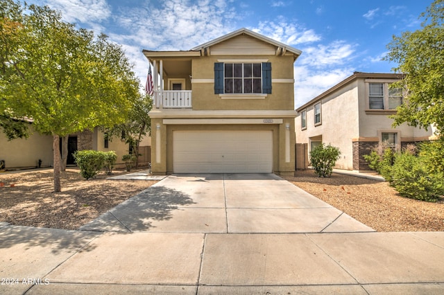 front of property featuring a balcony and a garage