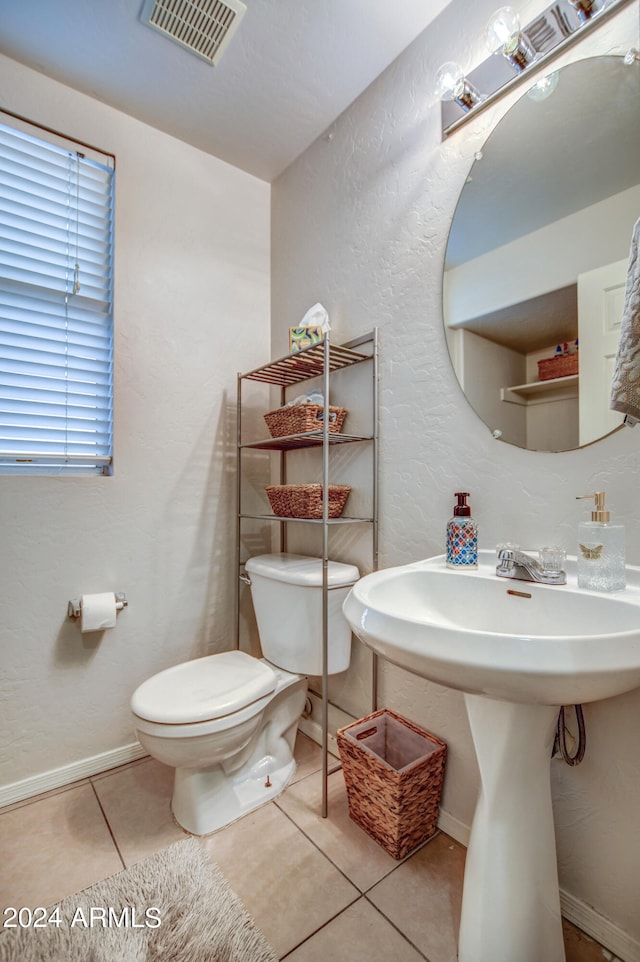 bathroom with tile patterned floors and toilet