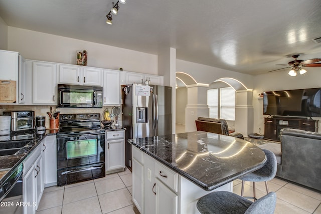 kitchen featuring a kitchen island, ceiling fan, black appliances, and white cabinets