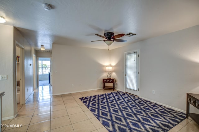 tiled bedroom with ceiling fan