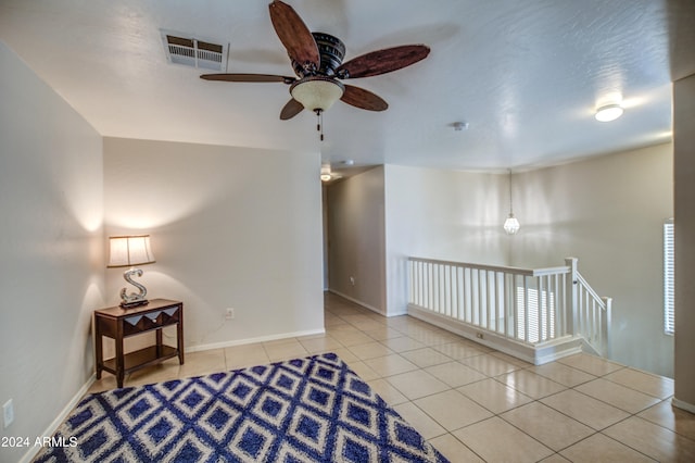 interior space featuring light tile patterned floors and ceiling fan