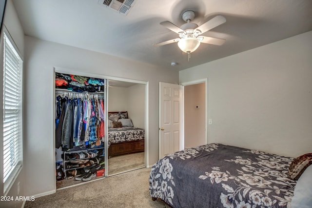 carpeted bedroom featuring ceiling fan and a closet