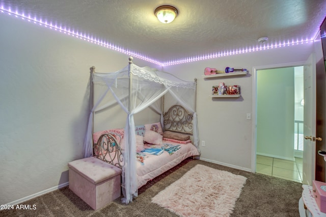 carpeted bedroom featuring a textured ceiling