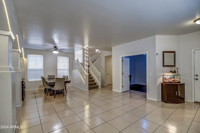 interior space with light tile patterned floors and ceiling fan