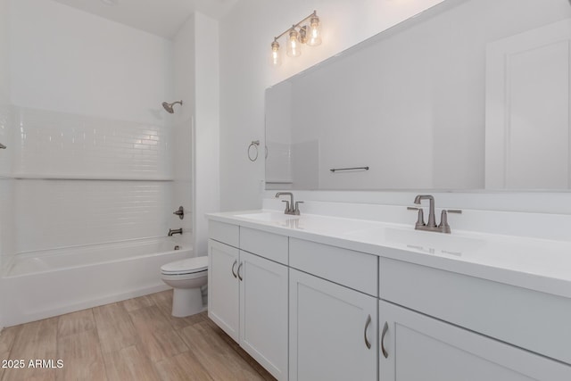 bathroom with shower / bath combination, a sink, toilet, and double vanity