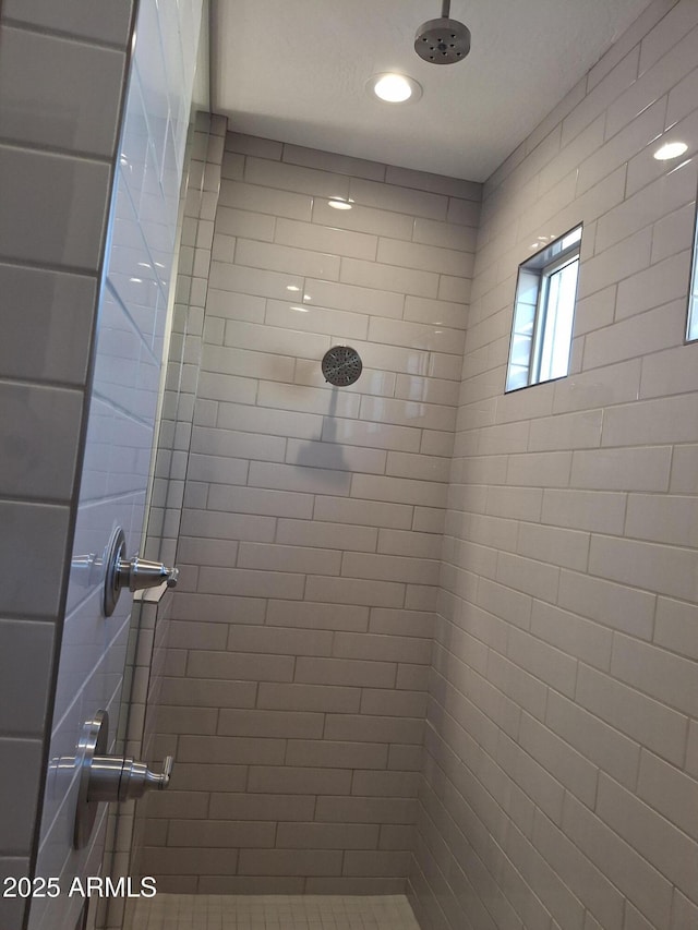 full bath with a tile shower