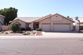 ranch-style house with a garage and driveway