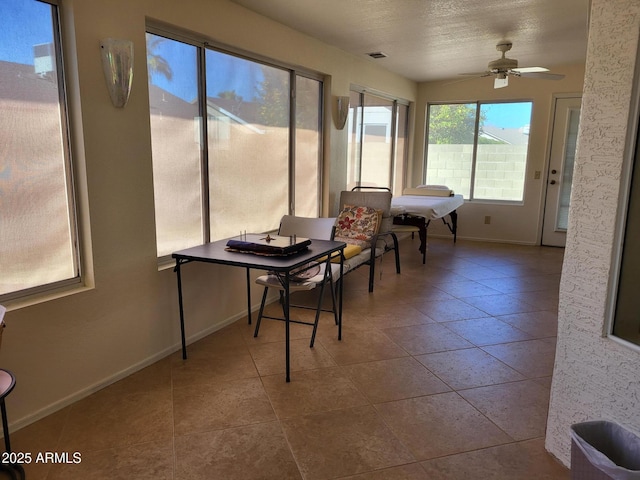 sunroom with ceiling fan, visible vents, and vaulted ceiling