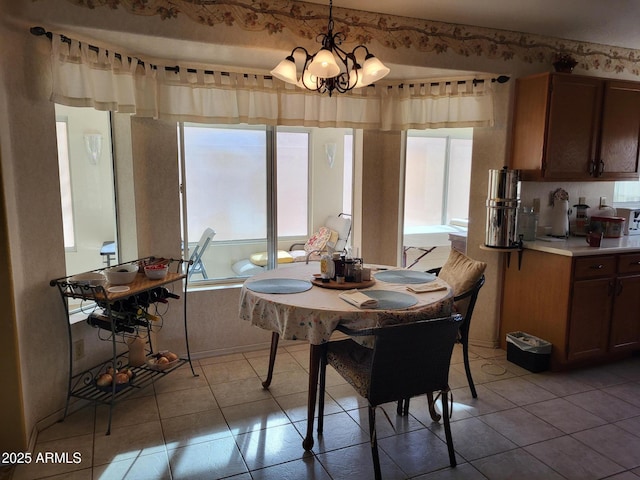 dining room with a chandelier and light tile patterned floors