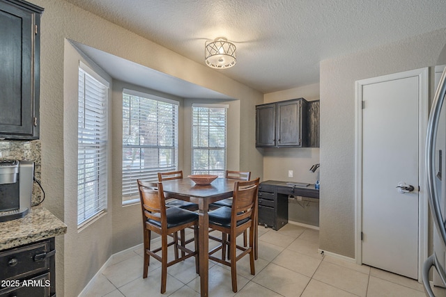 5911 E Evergreen St, Mesa, AZ 85205 - dining room with a textured wall, plenty of natural light, a textured ceiling, and light tile patterned floors