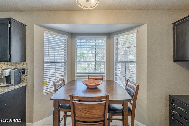 5911 E Evergreen St, Mesa, AZ 85205 - dining space with a textured wall and baseboards