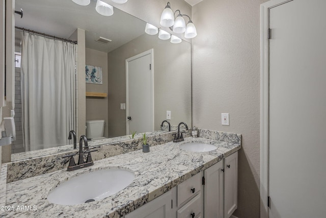5911 E Evergreen St, Mesa, AZ 85205 - bathroom featuring double vanity and a textured wall