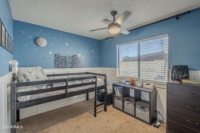 5911 E Evergreen St, Mesa, AZ 85205 - carpeted bedroom featuring a wainscoted wall, a textured ceiling, and a ceiling fan