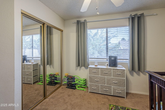 5911 E Evergreen St, Mesa, AZ 85205 - carpeted bedroom featuring a textured ceiling, a closet, and ceiling fan