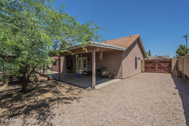 5911 E Evergreen St, Mesa, AZ 85205 - rear view of property with a gate, french doors, stucco siding, a patio, and a tile roof