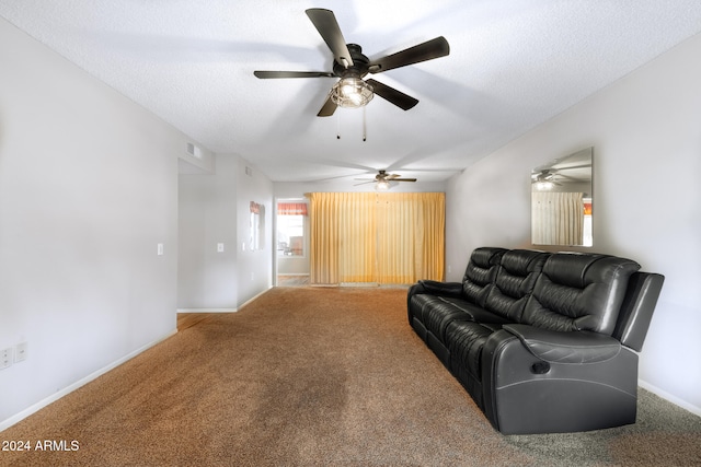 living room featuring ceiling fan, a textured ceiling, and carpet