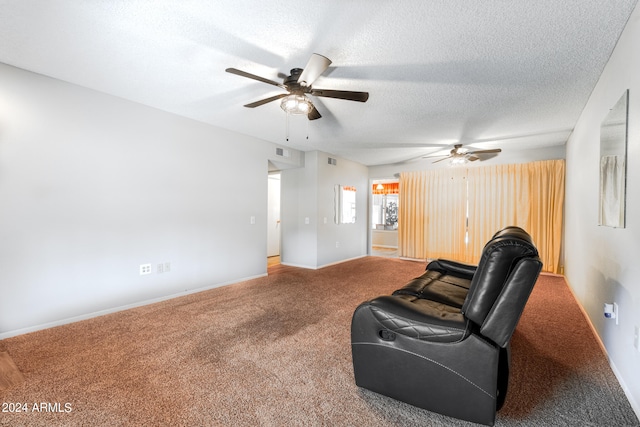 living room with ceiling fan, carpet, and a textured ceiling