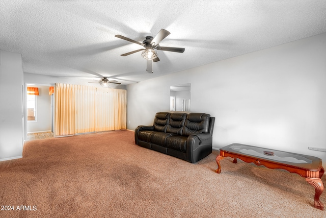 carpeted living room with ceiling fan and a textured ceiling