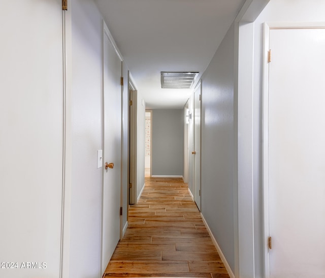 corridor featuring light hardwood / wood-style floors