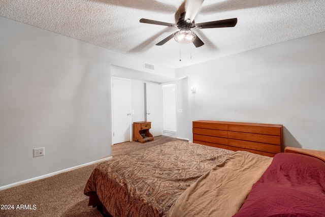 bedroom featuring ceiling fan, a textured ceiling, and carpet floors