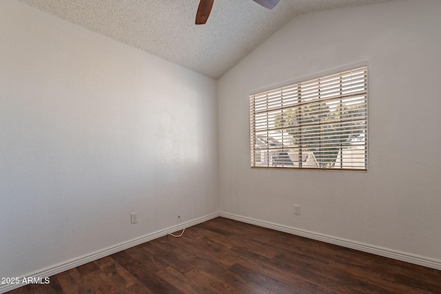 empty room featuring ceiling fan, lofted ceiling, a textured ceiling, and dark hardwood / wood-style flooring