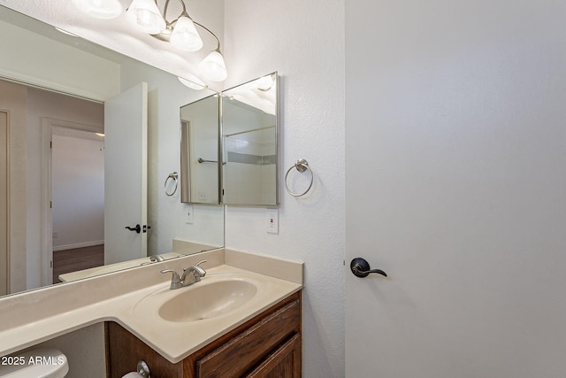 bathroom featuring vanity and toilet