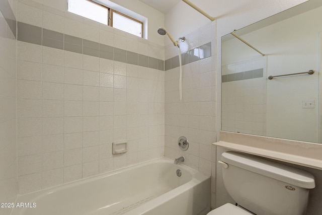 bathroom with toilet and tiled shower / bath combo