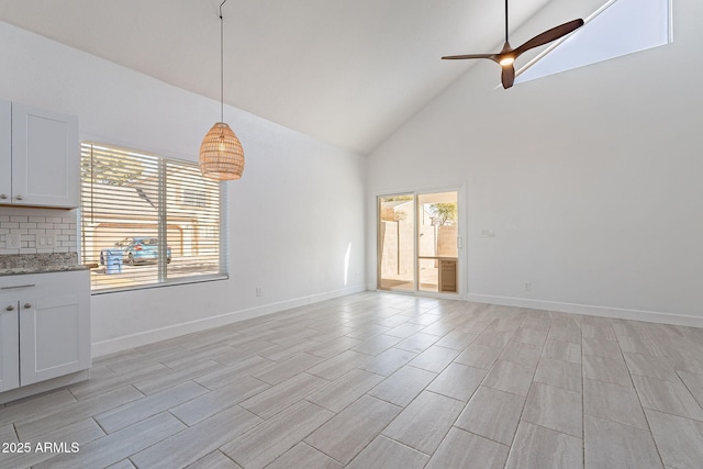 interior space with high vaulted ceiling and ceiling fan