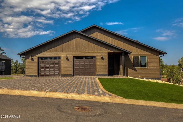 view of front of property with a garage and a front lawn