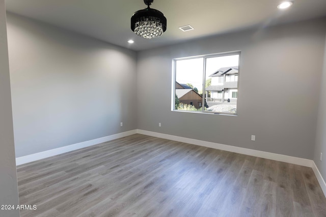 empty room with light hardwood / wood-style flooring