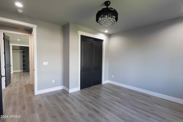 unfurnished bedroom with a closet and light wood-type flooring