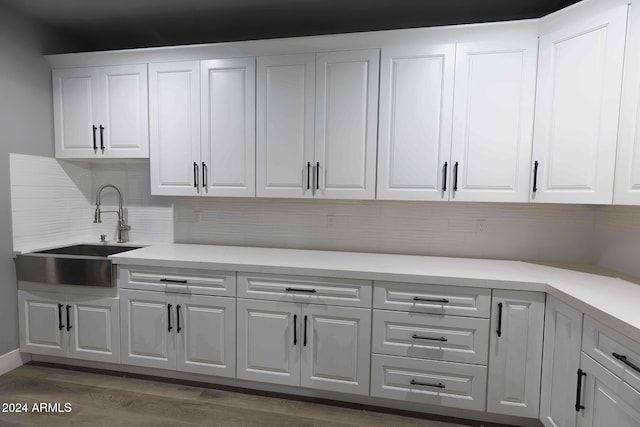 laundry area with dark hardwood / wood-style floors and sink