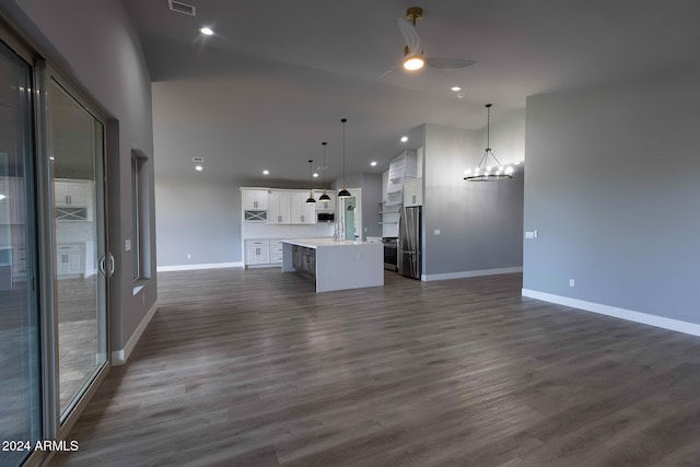 unfurnished living room with dark hardwood / wood-style flooring and ceiling fan with notable chandelier