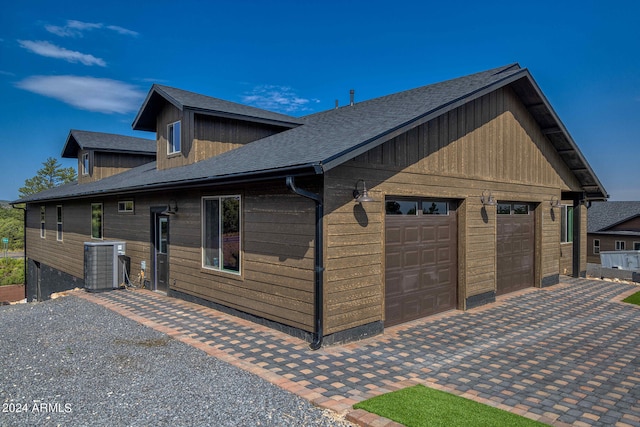 view of front facade with a garage and central AC unit