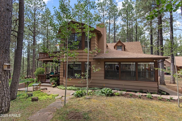 3910 Larson Loop, Forest Lakes, AZ 85931 - back of house featuring a chimney, a wooden deck, roof with shingles, and a sunroom