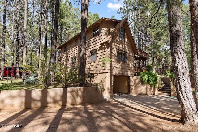 3910 Larson Loop, Forest Lakes, AZ 85931 - view of side of property featuring an attached garage, stairway, and driveway