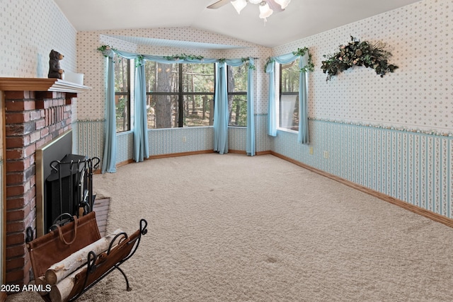 3910 Larson Loop, Forest Lakes, AZ 85931 - living area with wallpapered walls, vaulted ceiling, ceiling fan, carpet, and a brick fireplace