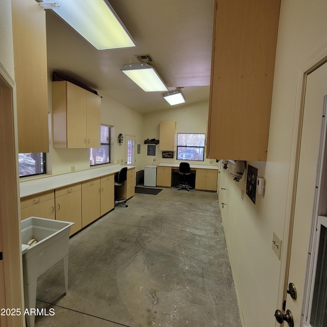 3910 Larson Loop, Forest Lakes, AZ 85931 - kitchen featuring concrete flooring, light countertops, and built in desk